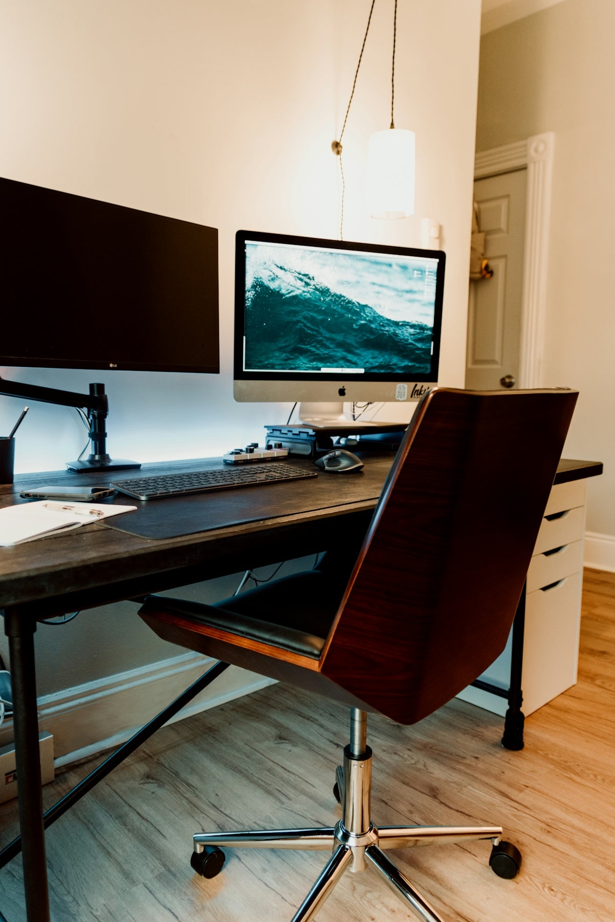 a desk with a monitor and keyboard on it