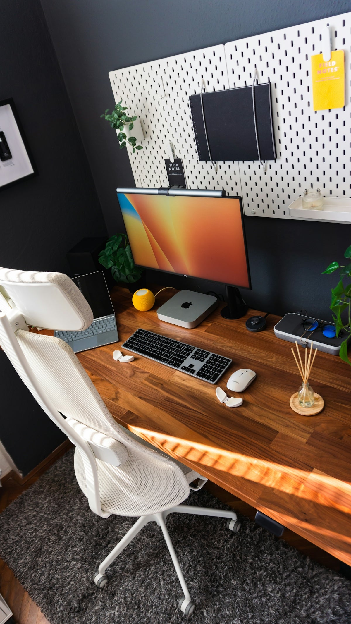 a wooden desk with a computer monitor and keyboard