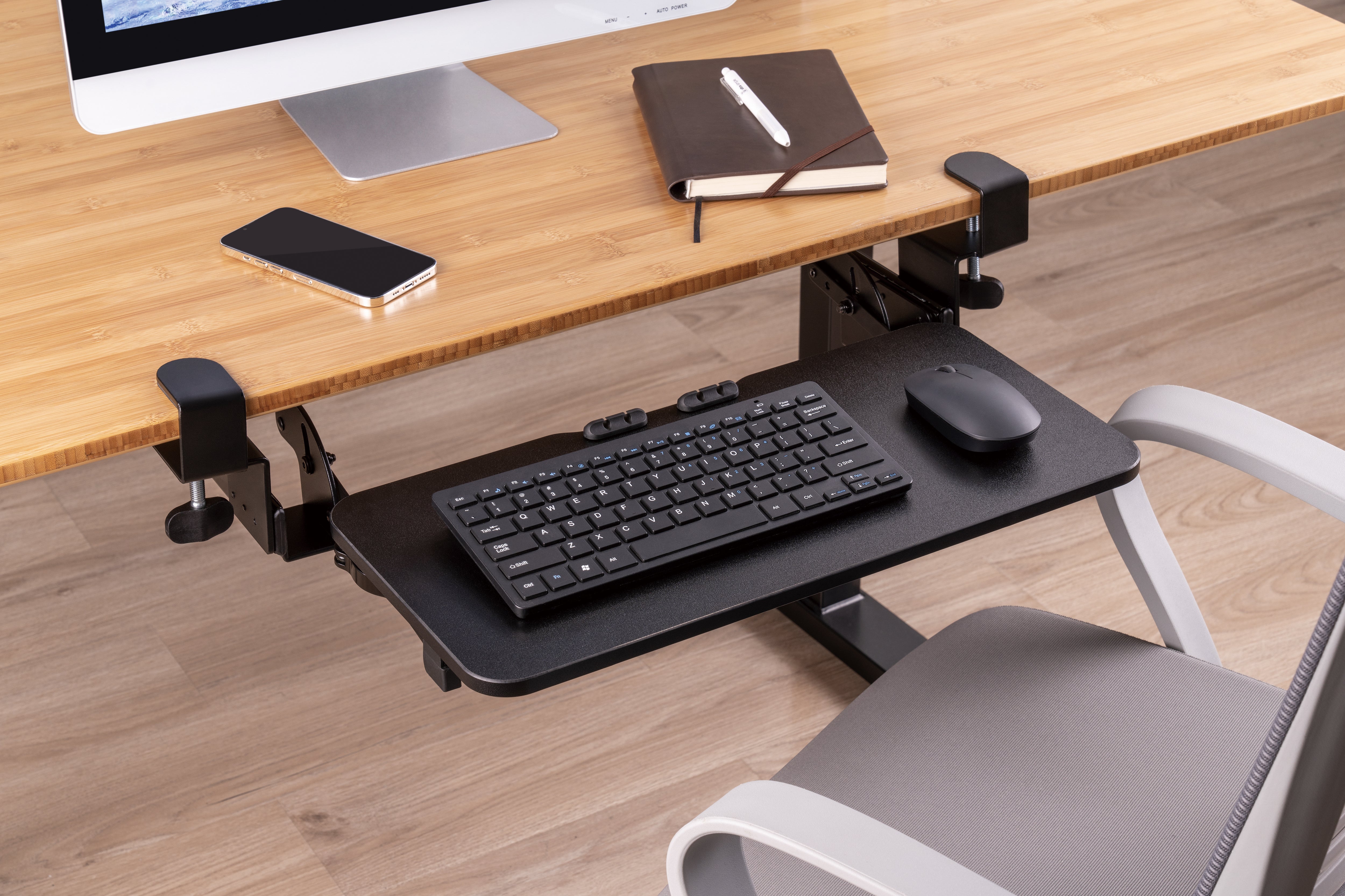 Висувна підставка для клавіатури OfficePro KT135B чорна — змонтована під столом з клавіатурою в інтер'єрі