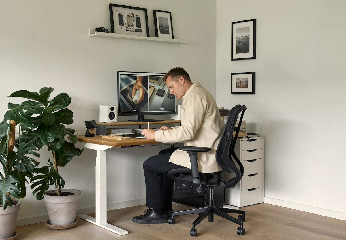 A man sitting at a desk in front of a computer